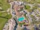 Aerial view of the community clubhouse featuring a pool and golf course at 5211 Mahogany Run Ave # 126, Sarasota, FL 34241