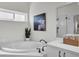 Modern bathroom featuring a soaking tub, walk-in shower, and white cabinets at 5211 Mahogany Run Ave # 126, Sarasota, FL 34241