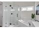 Modern bathroom features glass walk-in shower, soaking tub, and white subway tile at 5211 Mahogany Run Ave # 126, Sarasota, FL 34241