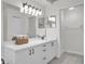 Bright bathroom with double sink vanity, tile floors, and well lit mirrors at 5211 Mahogany Run Ave # 126, Sarasota, FL 34241