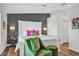 Bright primary bedroom featuring gray accent wall, wood floors, and luxury finishes at 5211 Mahogany Run Ave # 126, Sarasota, FL 34241