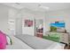 Bedroom features an ensuite bathroom, hard wood floors, and coastal style decor at 5211 Mahogany Run Ave # 126, Sarasota, FL 34241