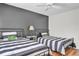 Shared bedroom featuring stylish twin beds, modern decor, and a well-lit, inviting atmosphere at 5211 Mahogany Run Ave # 126, Sarasota, FL 34241