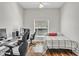 Functional bedroom featuring a desk with multiple monitors and a cozy bed, ideal for work and rest at 5211 Mahogany Run Ave # 126, Sarasota, FL 34241