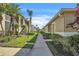 Landscaped walkway in a condo community, featuring lush greenery and well-maintained paths at 5211 Mahogany Run Ave # 126, Sarasota, FL 34241