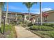 Condo community walkway with lush landscaping, offering a serene and well-maintained environment at 5211 Mahogany Run Ave # 126, Sarasota, FL 34241