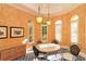 Bright breakfast nook with decorative walls, chandelier, round table and shutters on arched windows at 5211 Parisienne Pl # 101B27, Sarasota, FL 34238