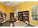 Community library with book shelves, reading tables, chairs, and natural light for a quiet and relaxing atmosphere at 5211 Parisienne Pl # 101B27, Sarasota, FL 34238