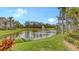 Scenic view of pond with water feature and landscaped grounds at 5211 Parisienne Pl # 101B27, Sarasota, FL 34238