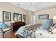 Cozy primary bedroom with a dark wood dresser and blue accents at 5662 Country Lakes Dr, Sarasota, FL 34243