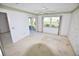 Light-filled bedroom with sliding glass doors, a large window, and traditional wallpaper at 5684 Sheffield Greene Cir # 79, Sarasota, FL 34235