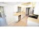 Efficient kitchen with white cabinets, a stainless steel dishwasher, and adjacent eating area at 5684 Sheffield Greene Cir # 79, Sarasota, FL 34235