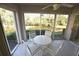 Enjoy pond views from this lovely lanai with seating for four and plenty of natural light at 5684 Sheffield Greene Cir # 79, Sarasota, FL 34235