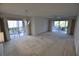 Bright living room featuring sliding glass doors to the patio and a decorative chandelier at 5684 Sheffield Greene Cir # 79, Sarasota, FL 34235
