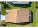Aerial view of house with brown roof, screened in lanai, and well maintained lawn at 5814 Garden Lakes Fern, Bradenton, FL 34203