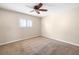 Cozy carpeted bedroom featuring a ceiling fan and a window with white shutters at 5814 Garden Lakes Fern, Bradenton, FL 34203