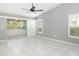 Spacious bedroom with vaulted ceiling, tiled floor, fan, and access to the lanai at 5814 Garden Lakes Fern, Bradenton, FL 34203