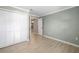 Bedroom with wood-look floors, closet and a view of the chandelier in the hallway at 5814 Garden Lakes Fern, Bradenton, FL 34203