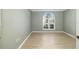 Bright bedroom with light-green walls, wood-look floors, and a lovely arch window with shutters at 5814 Garden Lakes Fern, Bradenton, FL 34203