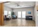 Open common area featuring hardwood floors, a ceiling fan, and comfortable seating at 5814 Garden Lakes Fern, Bradenton, FL 34203