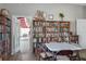 Community room with bookshelves and access to a brightly lit adjacent room at 5814 Garden Lakes Fern, Bradenton, FL 34203