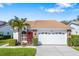 Charming single-story home with a well-maintained lawn, lush plants and a two-car garage at 5814 Garden Lakes Fern, Bradenton, FL 34203