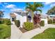 Charming home with beautiful lawn, palm tree, and stone accent features on the front exterior at 5814 Garden Lakes Fern, Bradenton, FL 34203