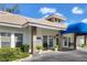 Charming single story home with a well-manicured front yard and inviting entrance with blue awning at 5814 Garden Lakes Fern, Bradenton, FL 34203
