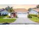 Charming home featuring a well-manicured lawn, tile roof, and an attached two-car garage at 5814 Garden Lakes Fern, Bradenton, FL 34203