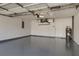 Spacious garage featuring epoxy floors, overhead lighting, and a hot water heater at 5814 Garden Lakes Fern, Bradenton, FL 34203