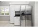 Kitchen with stainless steel refrigerator, white cabinets, and a dark countertop at 5814 Garden Lakes Fern, Bradenton, FL 34203