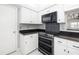 Well-lit kitchen featuring white cabinetry, granite countertops, and stainless steel appliances at 5814 Garden Lakes Fern, Bradenton, FL 34203