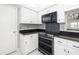 Modern kitchen with sleek stainless steel appliances and beautiful granite countertops at 5814 Garden Lakes Fern, Bradenton, FL 34203