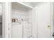 Convenient laundry closet features a washer, dryer, and wire shelving for storage at 5814 Garden Lakes Fern, Bradenton, FL 34203