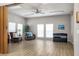 Cozy seating area with chairs, table, and plant. Large television, accordion doors, and natural light at 5814 Garden Lakes Fern, Bradenton, FL 34203