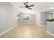 Open living space with wood-look flooring and fan, seamlessly connects to other rooms at 5814 Garden Lakes Fern, Bradenton, FL 34203