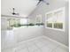 Bright living space with white tile flooring, ceiling fans, and plantation shutters at 5814 Garden Lakes Fern, Bradenton, FL 34203