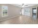 Spacious bedroom with hardwood floors, ceiling fan, sliding glass doors, and bright natural light at 5814 Garden Lakes Fern, Bradenton, FL 34203