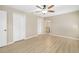 Large bedroom featuring wood-look floors, ceiling fan, a view to the bathroom, and closet at 5814 Garden Lakes Fern, Bradenton, FL 34203