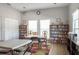 This meeting room features tables, chairs, and several bookshelves with books at 5814 Garden Lakes Fern, Bradenton, FL 34203