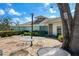 Outdoor brick patio area with tables and chairs, shaded by mature trees, great for relaxing at 5814 Garden Lakes Fern, Bradenton, FL 34203
