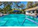 Outdoor community pool with clear water and a bright blue canopy for shade at 5814 Garden Lakes Fern, Bradenton, FL 34203