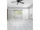 Bright sunroom features white tile flooring and sliding glass doors to the lanai at 5814 Garden Lakes Fern, Bradenton, FL 34203