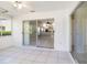 View of sunroom, tile floor, and open floor plan looking into living room. Sliding glass doors at 5814 Garden Lakes Fern, Bradenton, FL 34203