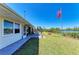 Expansive backyard with a covered patio, fire pit, and panoramic water views at 603 Ravenna N St, Nokomis, FL 34275