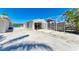 Open garage with a utility sink, workspace, and secure storage for outdoor equipment at 603 Ravenna N St, Nokomis, FL 34275
