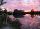 Beautiful sunset view over the water, creating a serene atmosphere in this scenic neighborhood at 603 Ravenna N St, Nokomis, FL 34275