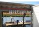 A picturesque dock with a fish hanging over the water, offering a serene waterfront experience at 603 Ravenna N St, Nokomis, FL 34275