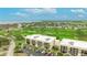 Stunning aerial shot of condo community and golf course, offering luxury living with scenic views of the Gulf at 6124 43Rd W St # 404A, Bradenton, FL 34210