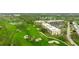 Expansive aerial view showcasing the condo complex, golf course, and lush green landscape at 6124 43Rd W St # 404A, Bradenton, FL 34210